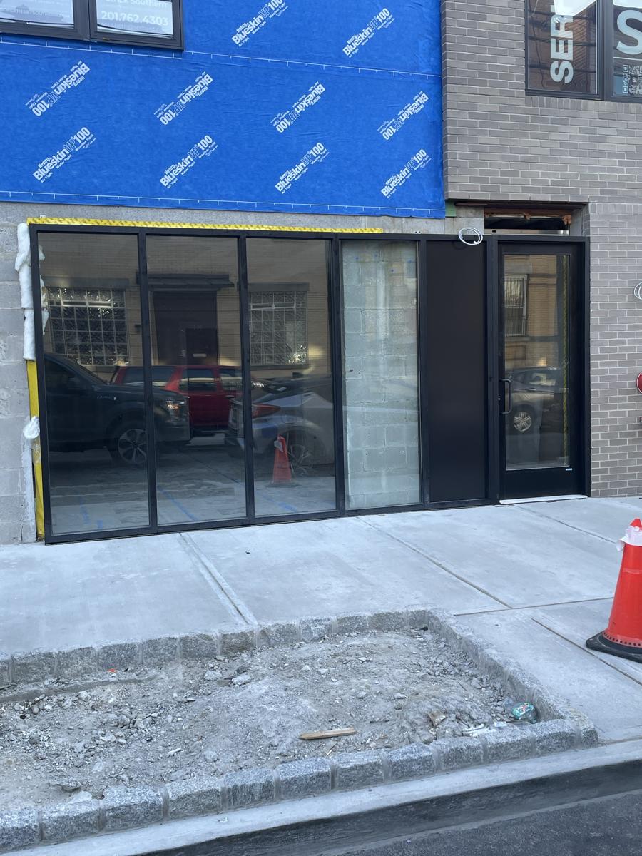 Black aluminum storefront with entrance door