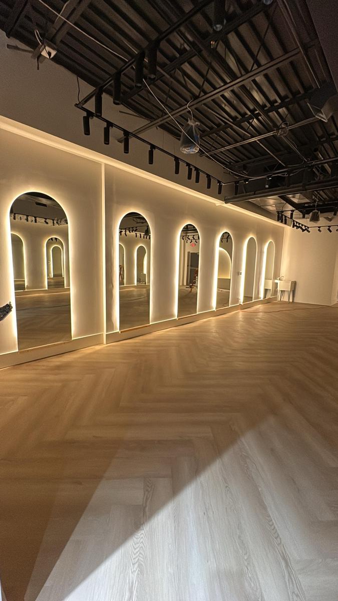 Arched backlit mirror wall in a fitness studio