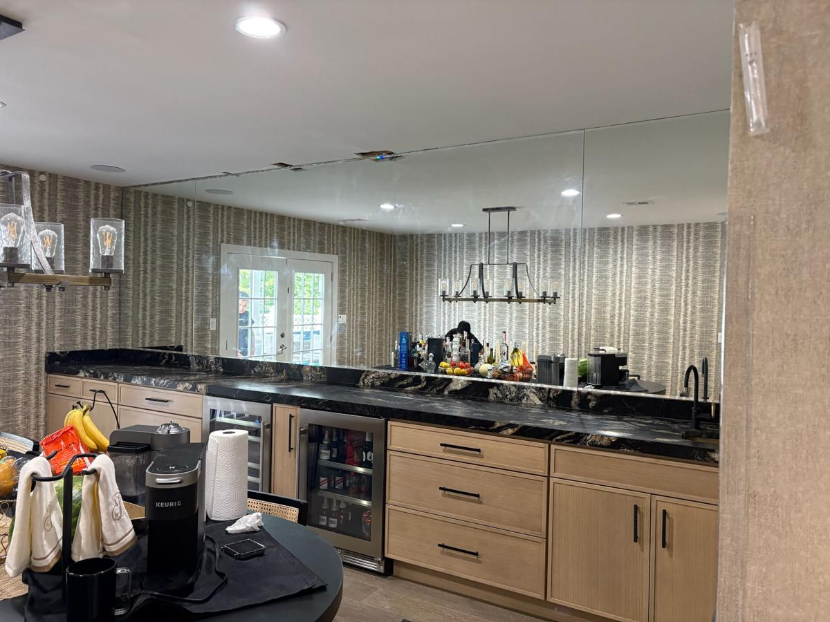 Full mirror wall behind a home bar