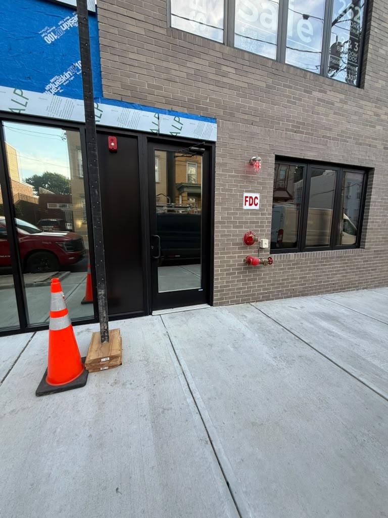 Black aluminum storefront entrance on a brick building