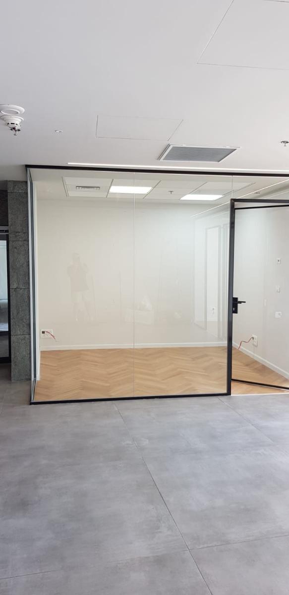 Black-frame glass office partition with door