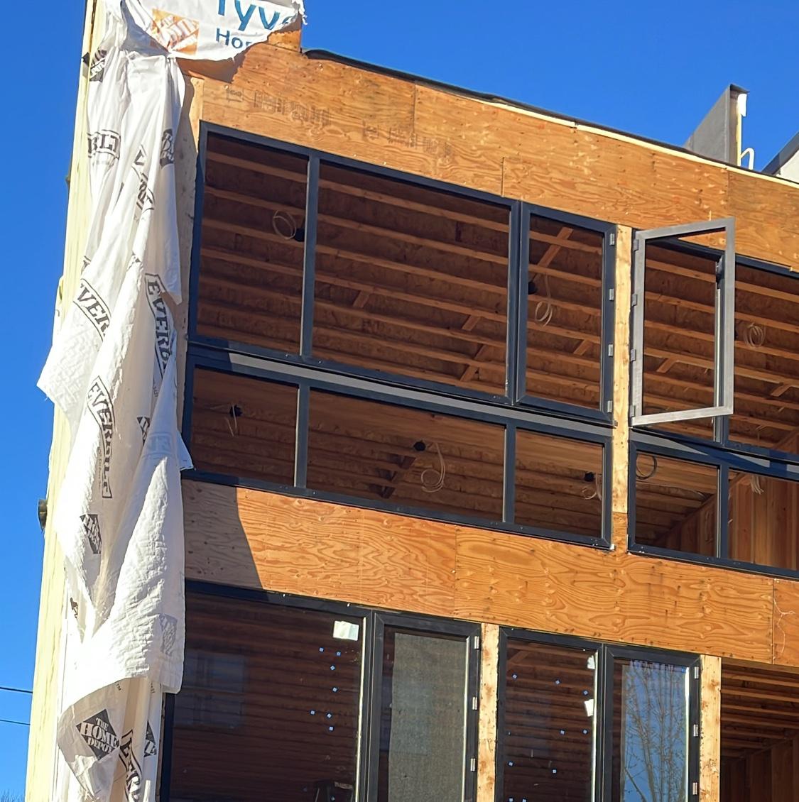 Black-frame window walls on new construction