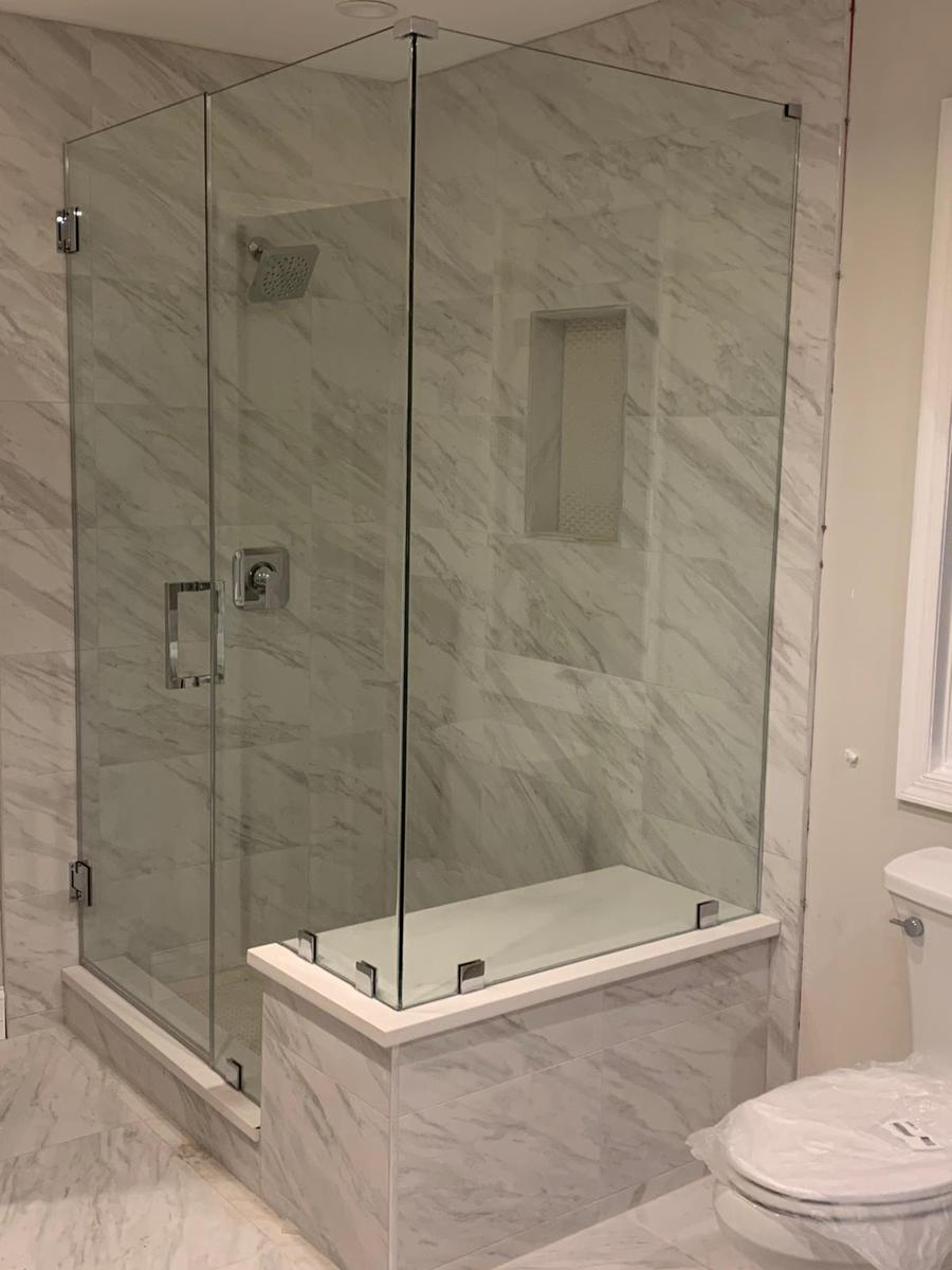 Corner frameless shower over a bench, chrome