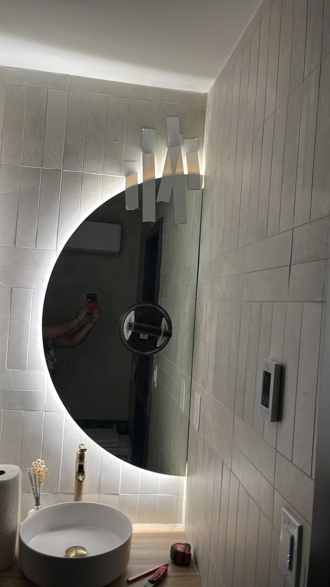 Custom half-moon backlit bathroom mirror