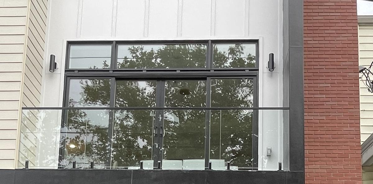 Exterior frameless glass balcony railing on a new townhouse