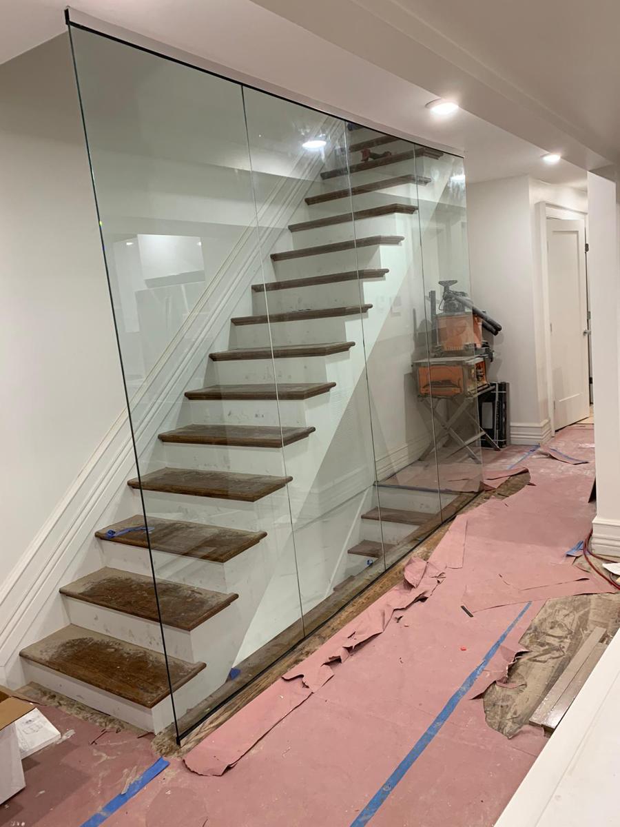 Glass wall enclosing a basement stair