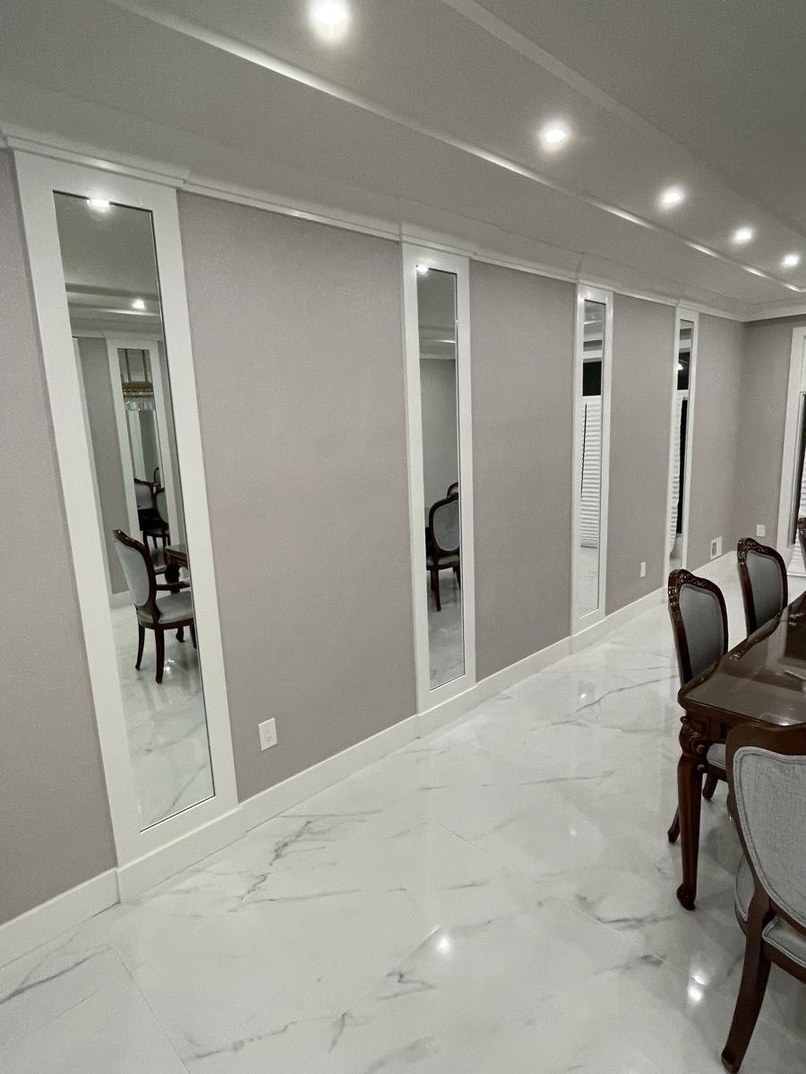 Tall mirror panels set into a dining room wall