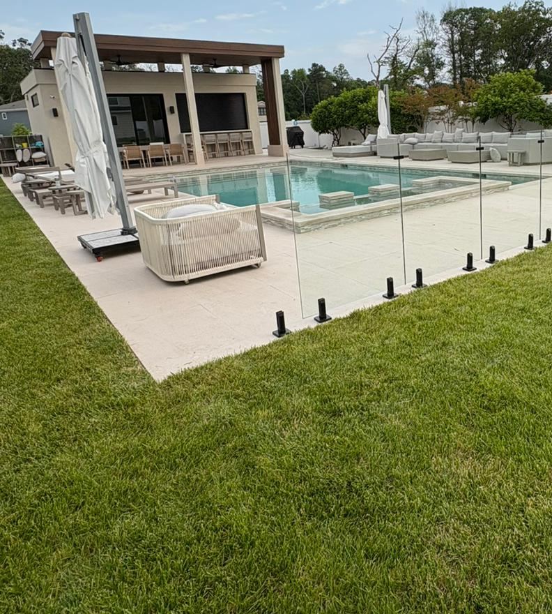 Frameless glass pool fence with black spigots