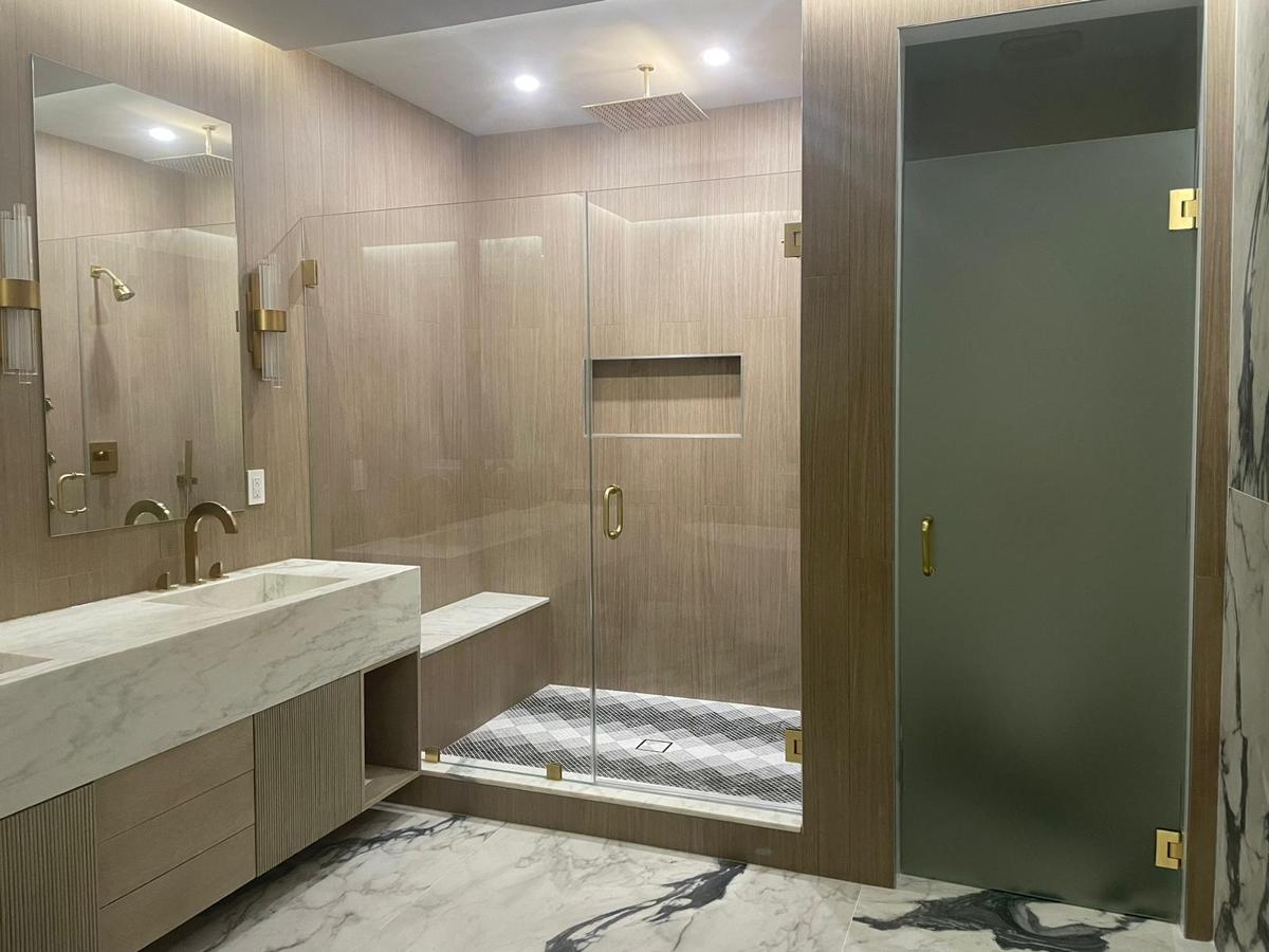 Frameless shower and frosted glass water closet door