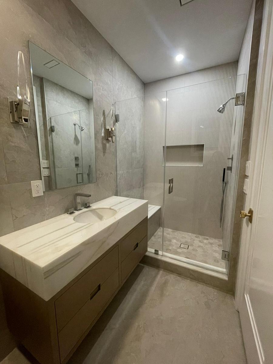 Frameless shower door with chrome hinges and fluted tile