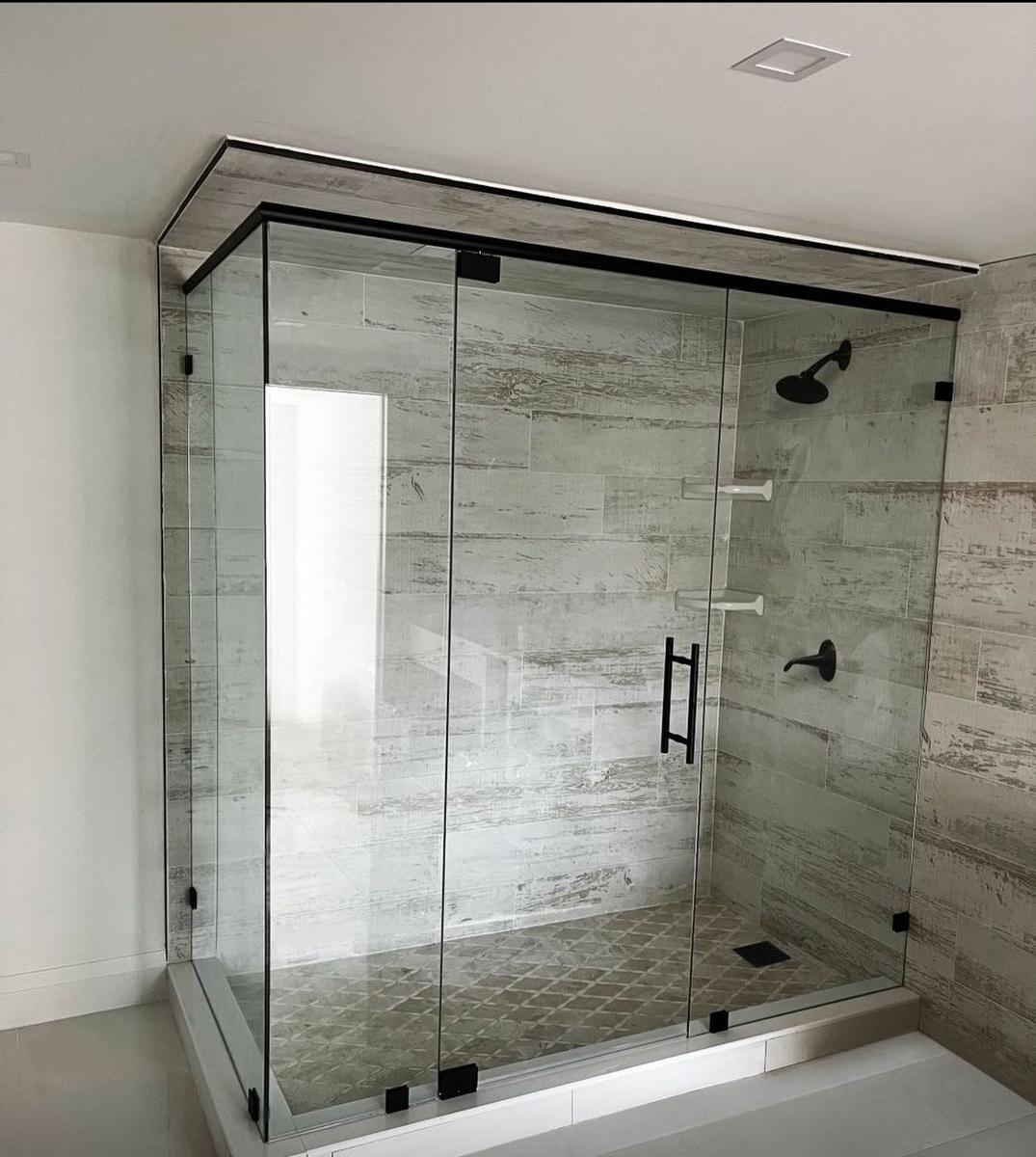 Large frameless shower enclosure with matte black header and hardware