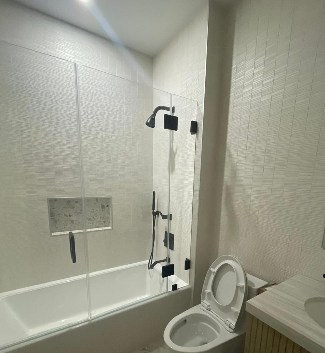Frameless bathtub door and panel with matte black hinges