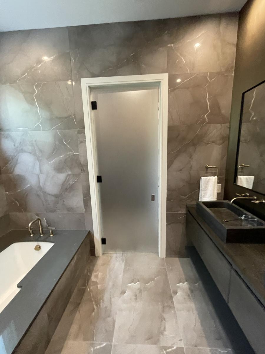 Frosted frameless glass door with black hinges