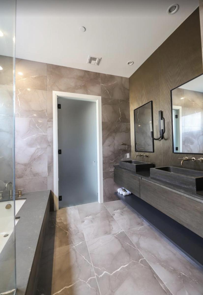 Frosted glass water closet door in a marble bathroom
