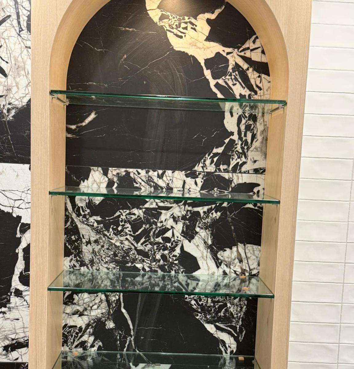 Glass display shelves in an arched niche