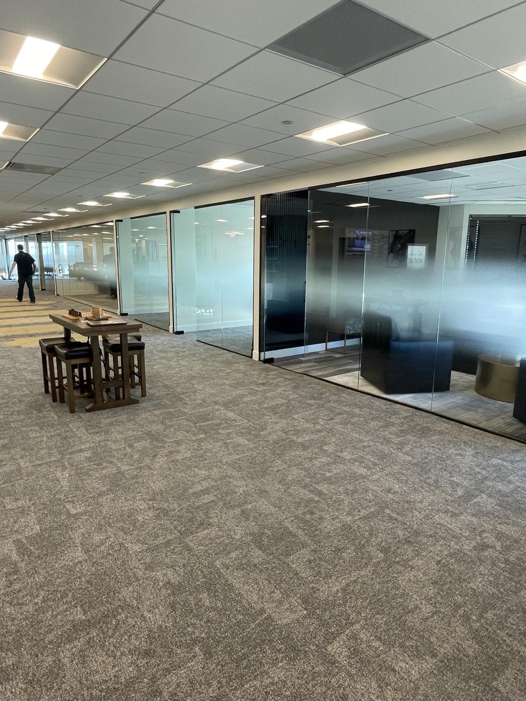 Corridor of frameless glass office fronts