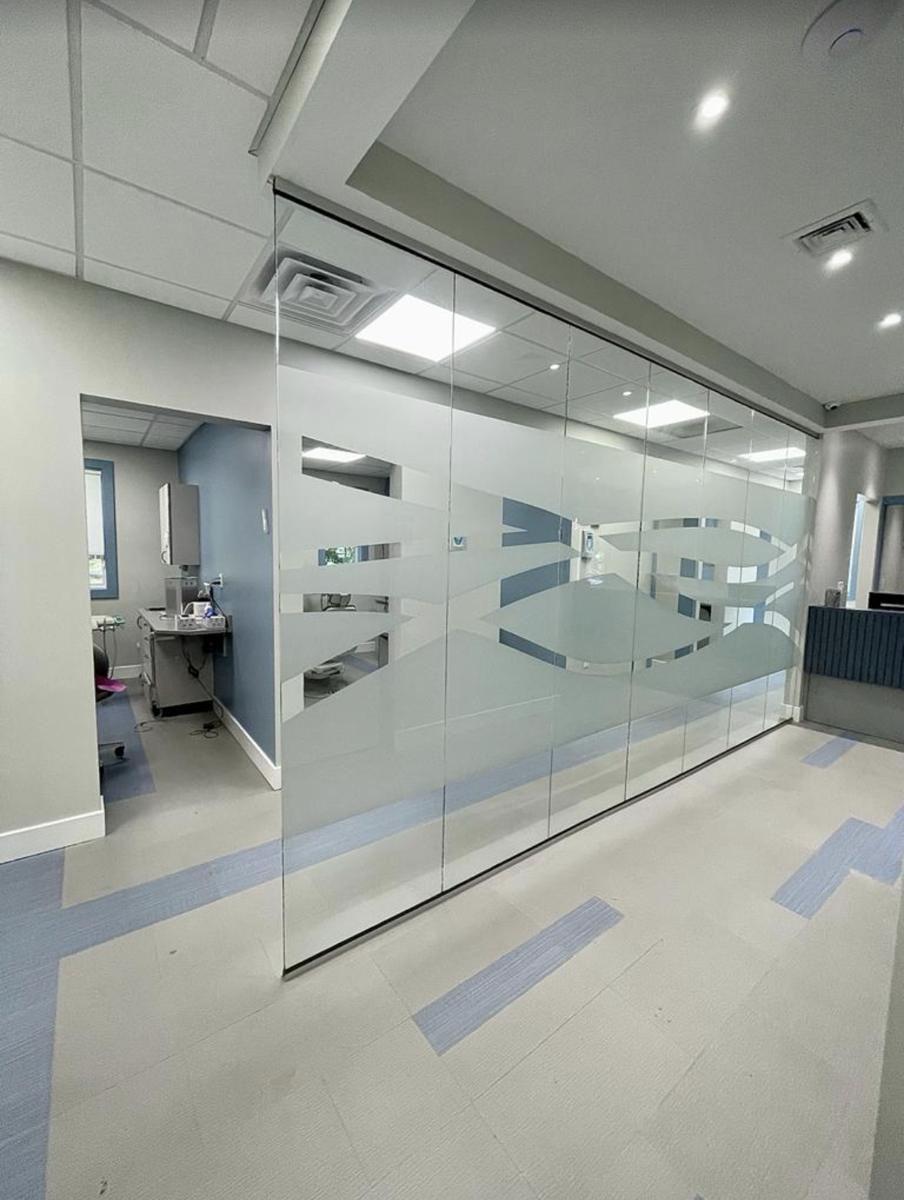 Glass partition with decorative frosted film in a medical office