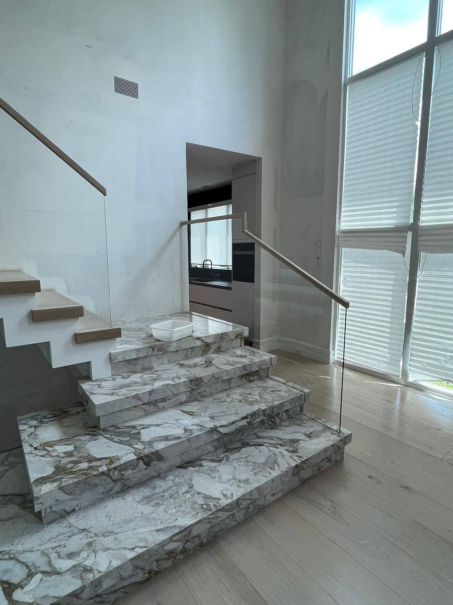 Frameless glass railing on marble stairs