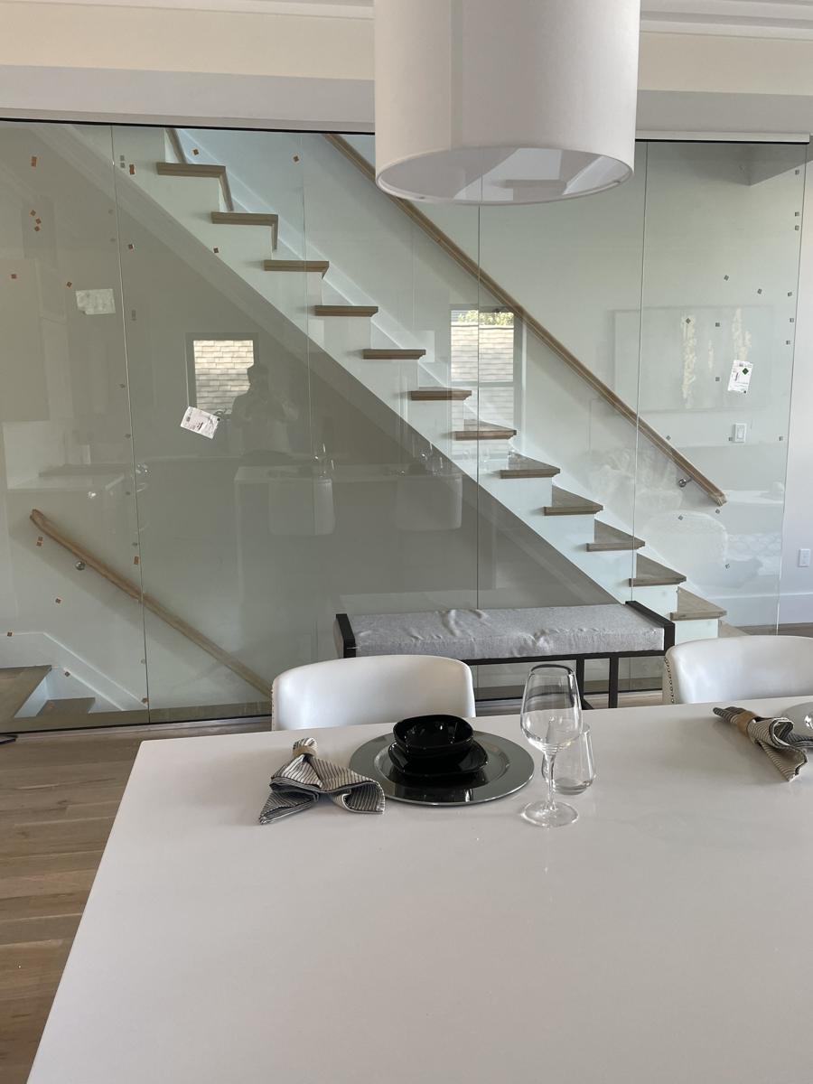 Floor-to-ceiling glass wall along a staircase