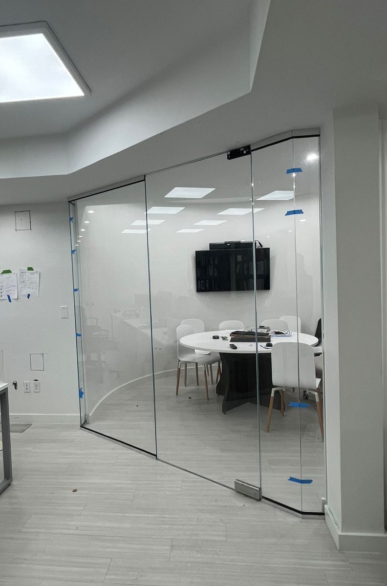 Curved glass conference room front during installation