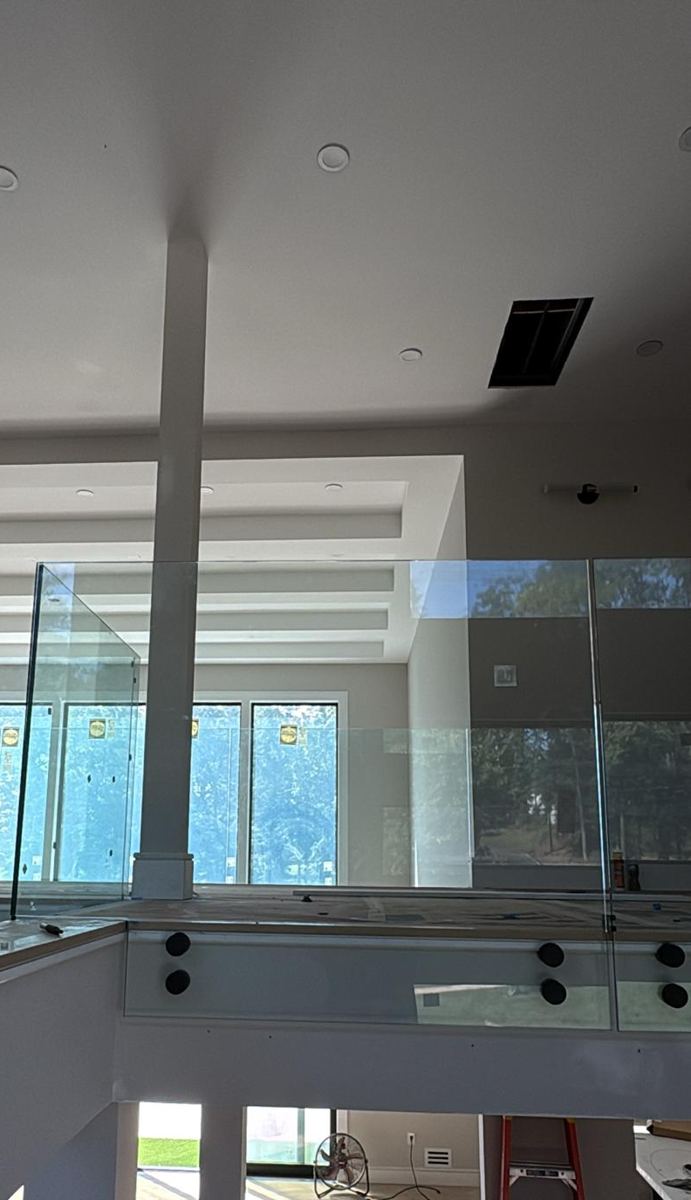 Glass loft railing on standoffs during installation