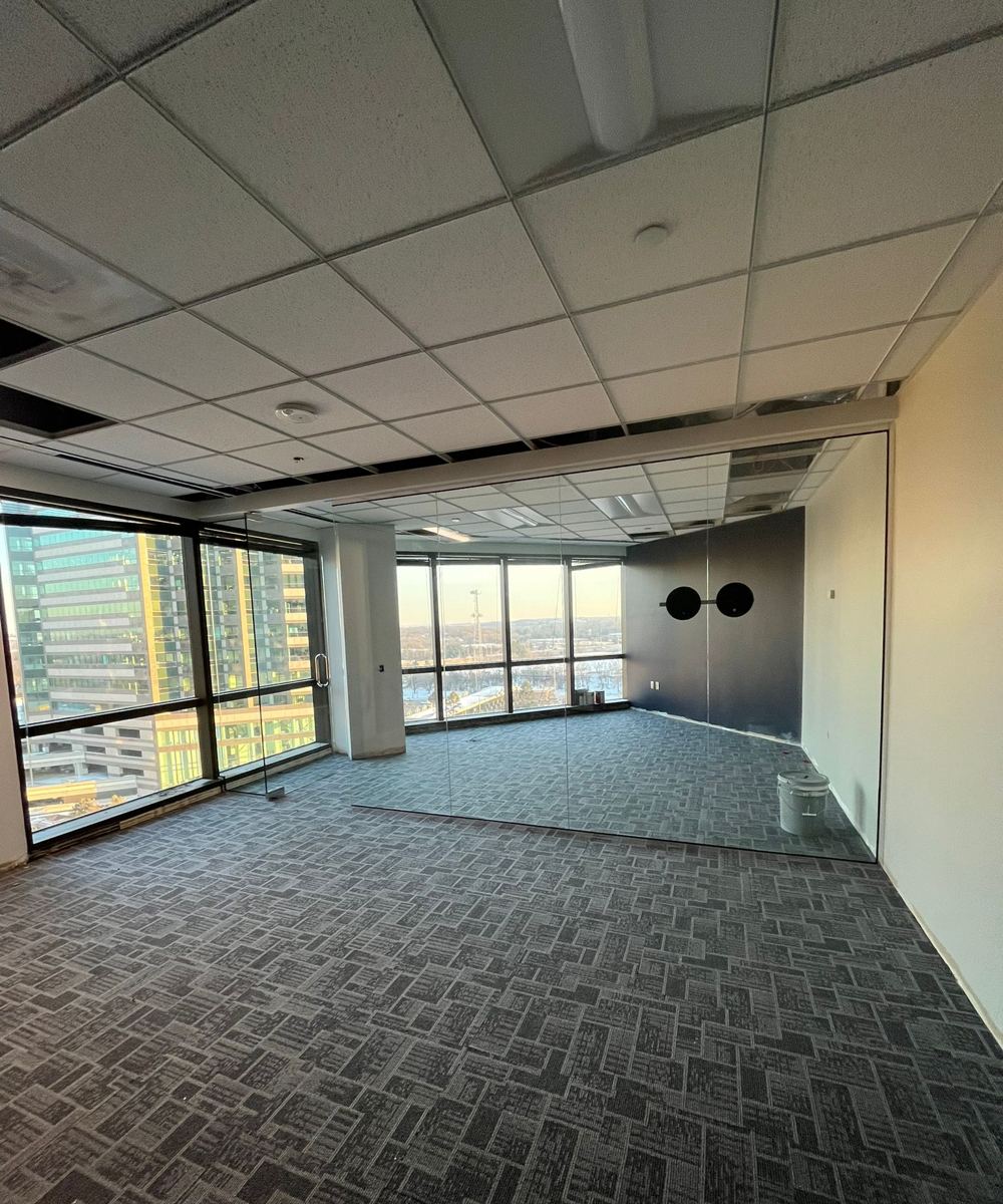 Installing frameless glass office walls on a high-rise floor