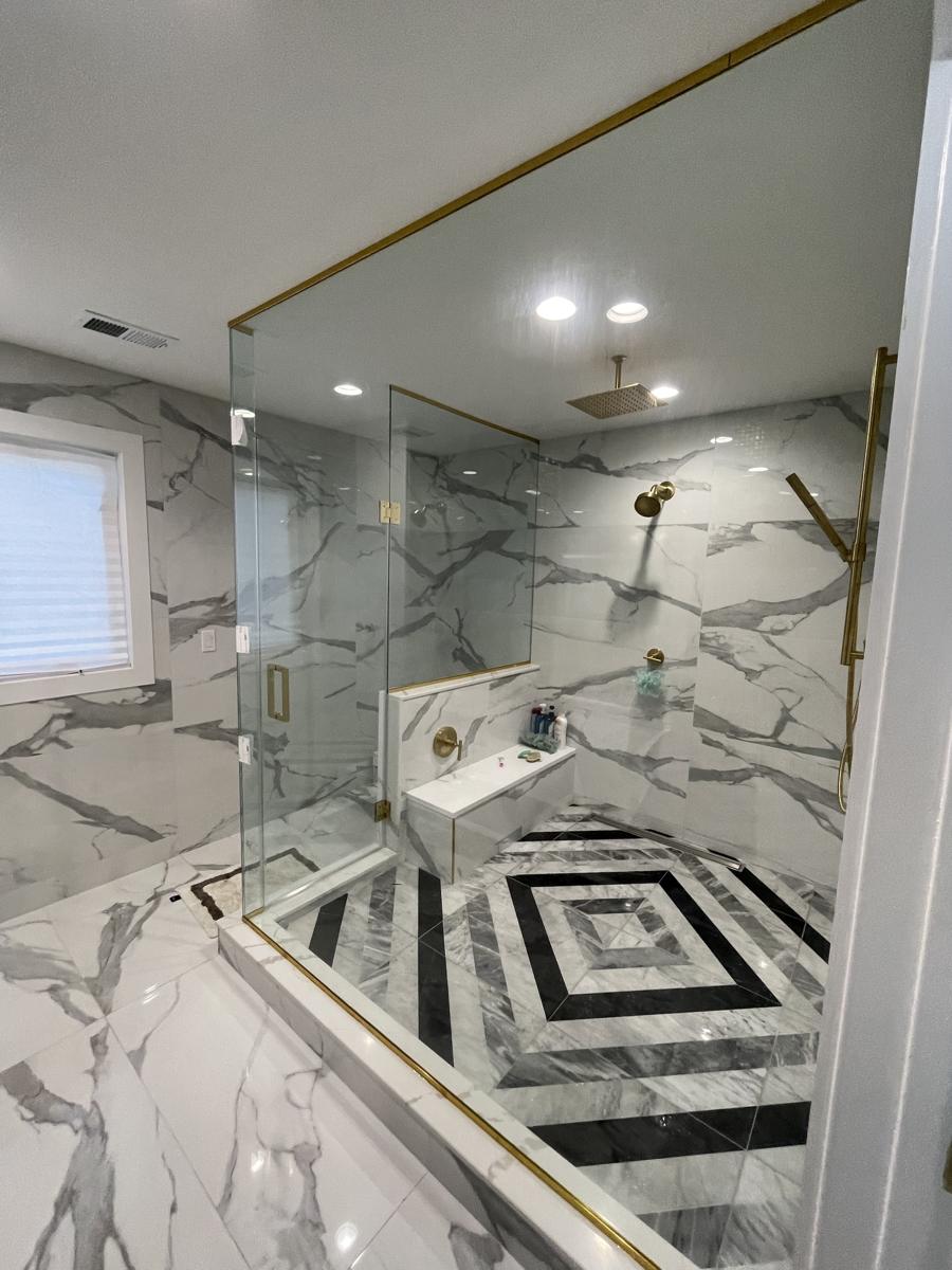 Large walk-in shower glass with gold channel in Oakhurst, NJ