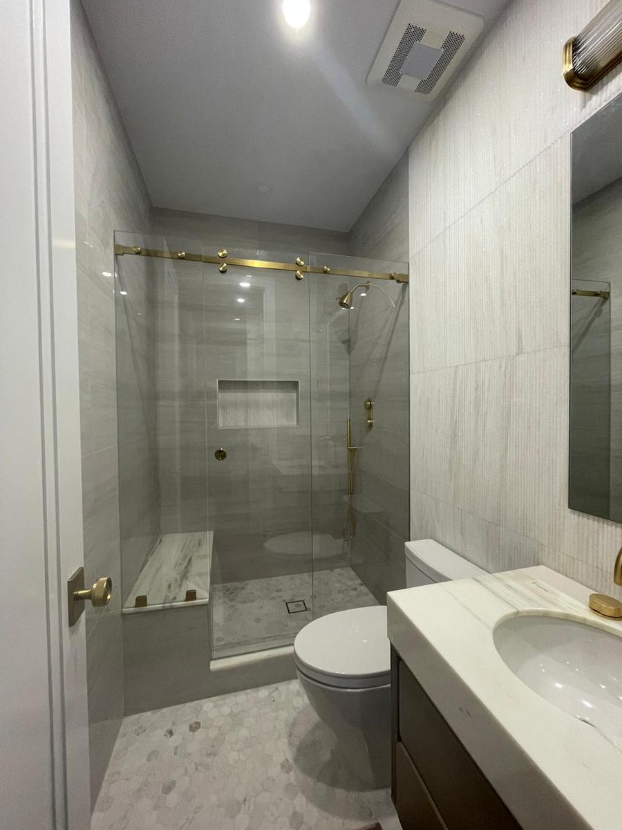 Sliding shower door with brushed gold rollers