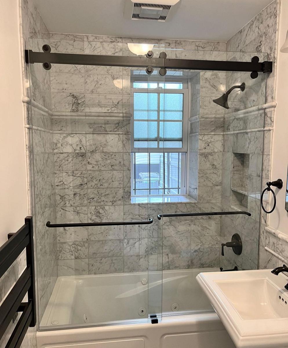 Sliding bathtub door with matte black track