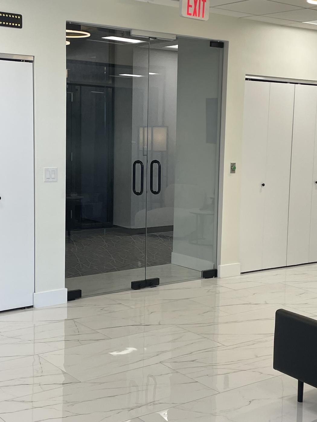 Smoked glass double entry doors in an office lobby
