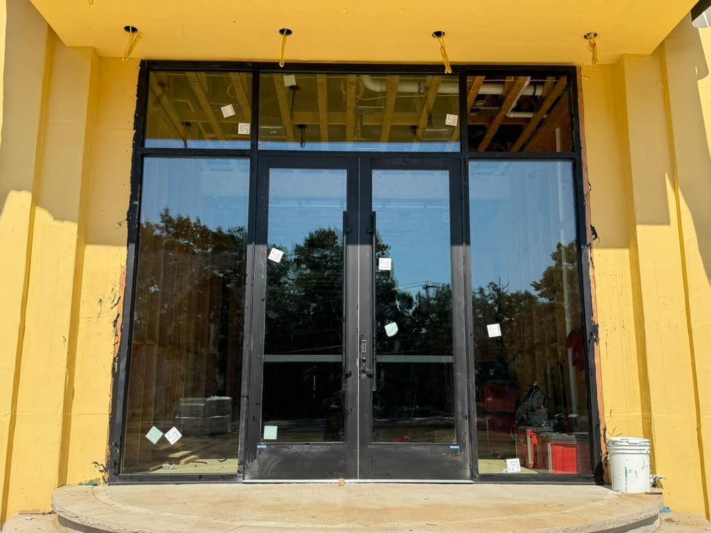 Black aluminum storefront with double doors and transom